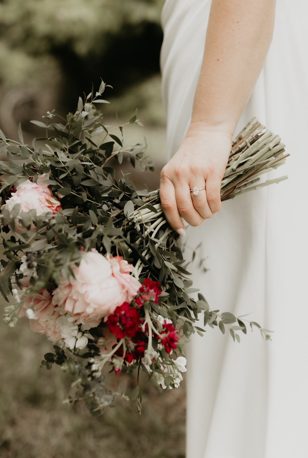 Wedding Bouquet of flowers held by a bride in a white dress.